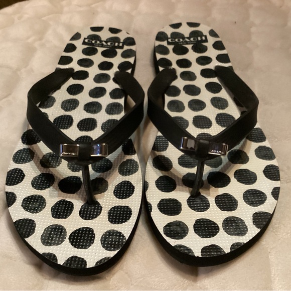 Coach flip flops in white and black polka dots straps adorned with silver bows. - Picture 1 of 6